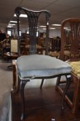 An Edwardian mahogany salon chair