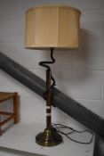 A modern brushed and twisted metal table lamp, with peach coloured material shade 84cm overall