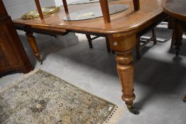 A Victorian oak extending dining table on turned legs , approx. 190 x 126cm extended