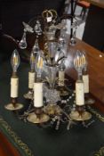 A brass and glass six branch electric chandelier light fitting , with suspended drops and faux