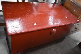 A Victorian pine blanket box, of traditional design with internal candlebox, later red painted