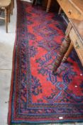 A large Turkish woollen runner, of typical design with rich vibrant colours, reds, blues and greens,