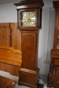 A George III oak eight day long case clock, the flat topped hood with ogee surmount over the