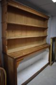 A large Victorian pine dresser base with large open section and planked base 96cm x 214cm sold along