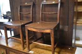 A pair of 19th century mahogany chairs, having graduated ball turned mid rails and dished solid