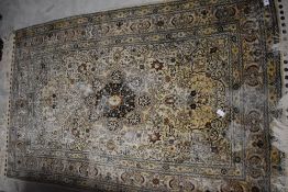 An Eastern silk type rug, possibly Indian or Pakistani origin, decorated with a central foliate pole