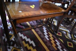 A reproduction mahogany sofa table, in the regency style with reeded down-swept legs 49cm high