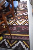 A modern machine made room carpet of rug, replicating a Kilim flatweave design 275cm long