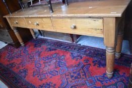 A large pine three drawer dresser base, with turned legs 211cm long