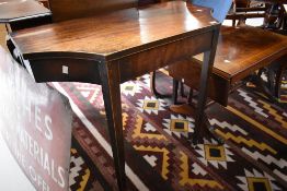 A George III mahogany side table, of rectangular form with re-entrant front corners, formally a