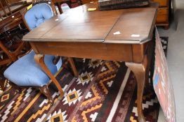 A mid 20th century mahogany ladies writing desk, with three section hinged and canted rectangular