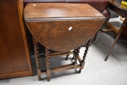 A small barley-twist oak gate-legged table, of typical design 73cm high