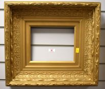 A decorative gilt-painted and moulded picture frame, in the 19th century style of broad swept,