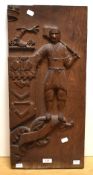 19th/20th Century, a stained oak panel carved in relief with a Yeoman beside heraldic symbols,