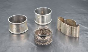 A group of four late 19th/early 20th century napkin rings, three of circular form and one of a bow