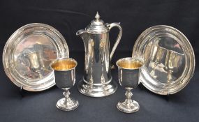 A cased Victorian silver communion set, comprising two chalices, two patens and claret jug, the