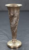 A late Victorian silver vase, having a flared rim and fluted body with decorative embossed floral