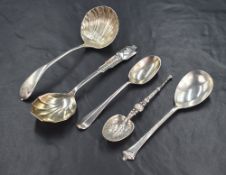 A group of four silver spoons, including an Annointing spoon replica, a sauce ladle and a
