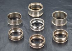 A group of seven early 20th century silver napkin rings, of various size and design including
