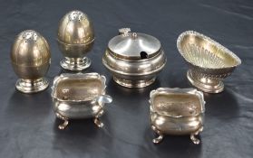 A pair of Victorian silver egg motif pepperettes, raised on circular step moulded feet, marks for