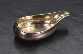 A George III silver sauce boat of circular elongated form, having a shallow spout with no handle