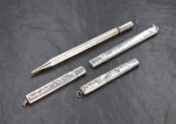 Four early 20th century silver mounted pencils, two having decorative engraving and one being
