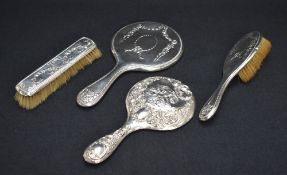 An early 20th century silver mounted vanity set, comprising a hair brush, clothes brush and a
