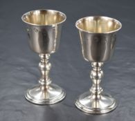 A pair of Elizabeth II silver goblets, of traditional form having knopped stems raised on circular