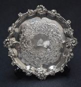 A Victorian silver visiting card tray, of circular form having embossed floral rim with shell and