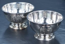 A pair of George V silver footed bowls, having slightly flared step moulded rims, with embossed