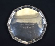 A George V silver salver, having gadrooned rim and lobed sides with a central engraving of 'W.T.