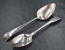 A George III silver fiddle pattern serving spoons, having a heraldic crest to the terminal, marks