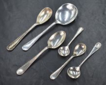 A group of six silver spoons, comprising condiment spoons and a soup spoon, including bead thread