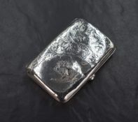 An early George V silver cigarette case of hinged rectangular form, having decorative scroll