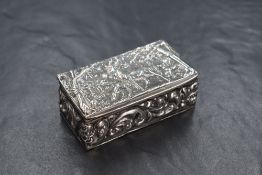An Edwardian silver trinket box, of rectangular form having an embossed scene of a herd of deer in a