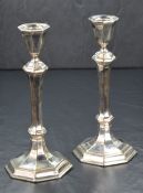 A pair of Elizabeth II silver candlesticks, of turned octagonal form having octagonal scones, raised