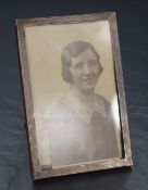 A George V silver mounted wooden photograph frame, of rectangular form having engine turned
