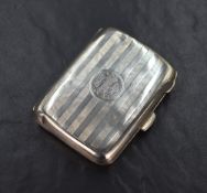 A George V silver cigarette case of hinged rectangular form slightly curved for the gentleman's