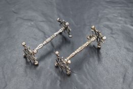 A pair of Victorian silver knife rests, of knopped form having decorative pierced ends, marks for