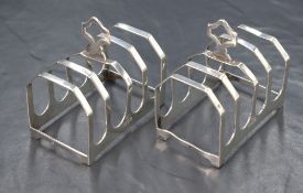 A pair of George V silver toast racks, of traditional form with pierced handles, marks for Sheffield