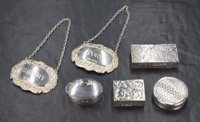 A group of four Elizabeth II silver pill boxes, comprising one of rectangular form having scroll