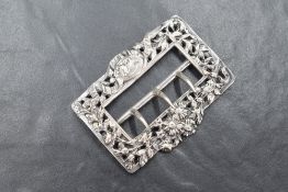 A Victorian silver belt buckle, having embossed pieced floral work with ribbon swags and a maiden in