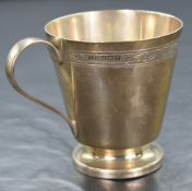 A George VI silver cup, of traditional form having engraved scroll decoration collar, on a