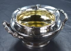 A William IV silver double handled bowl, of circular form having a flared rim with fluted