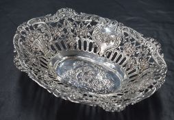 An 800. grade white metal dish, of oval form having ornate pierced sides comprising embossed baskets