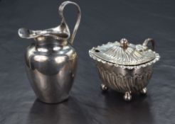 A Victorian silver cream jug, of rounded form having a wide shallow spout opposed by a reed s-
