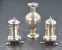 A pair of early 20th century silver pepperettes, of bulbous form raised on three cabriole style