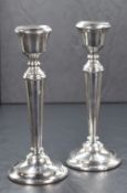 A pair of Elizabeth II silver candlesticks, of traditional form having moulded sconces with