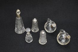A group of six silver mounted cut glass wares, comprising a salt and pepper shaker, two scent