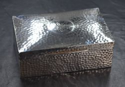 An Edwardian silver cigarette box, of hinged rectangular form having engraved circular cartouche